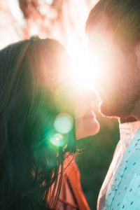 Couple about to kiss in the sun